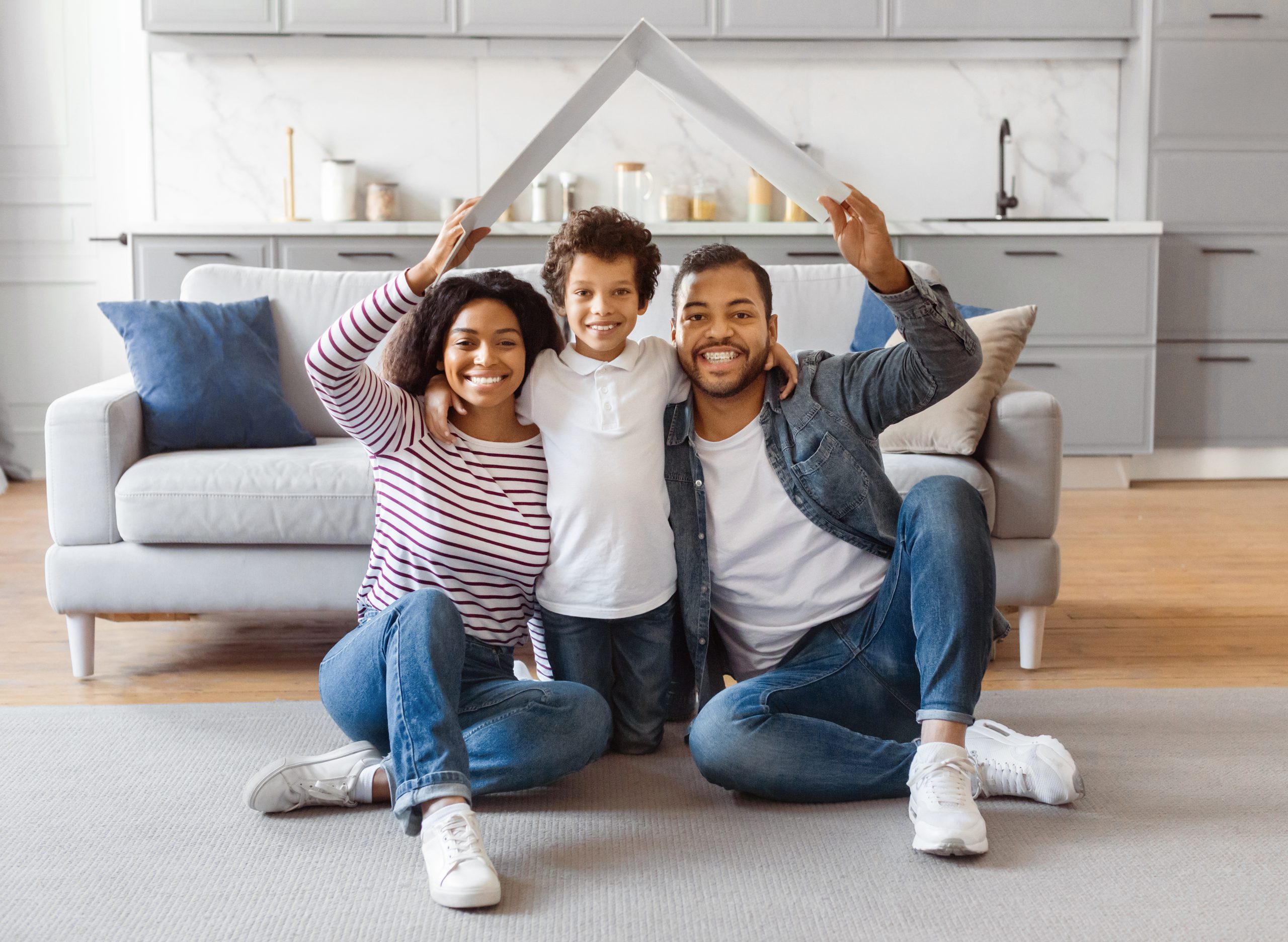 Family Sitting on Floor in Front of Couch Calgary Equity Loans home page image of a happy family